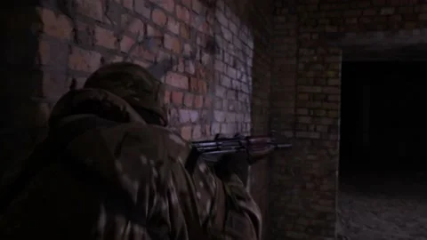 Fully equipped, armed soldier during a reconnaissance mission in an unfinished Stock Footage 132421803