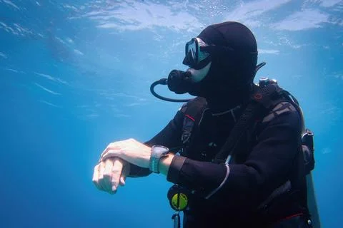 Fully equipped man scuba diver underwater in the blue water 写真素材