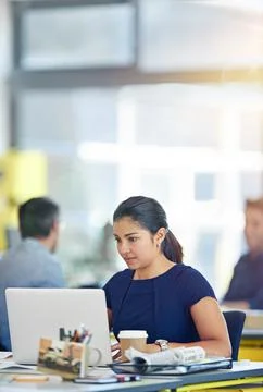 Fully focused on her tasks. a young woman working at her computer in an office. Foto stock