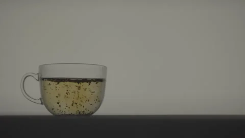 Fully Infused Green Tea With Diffused Color in Transparent Glass Stock Footage 346364211