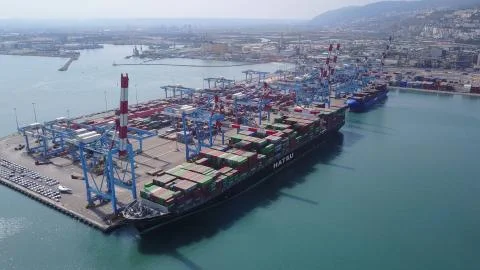 Fully loaded container ships docked at freight port terminal Stock Photos