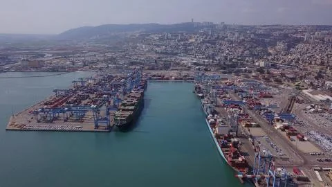 Fully loaded container ships docked at freight port terminal Stock Photos