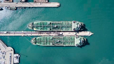 Fully loaded container ships docked at freight port terminal Stock Photos