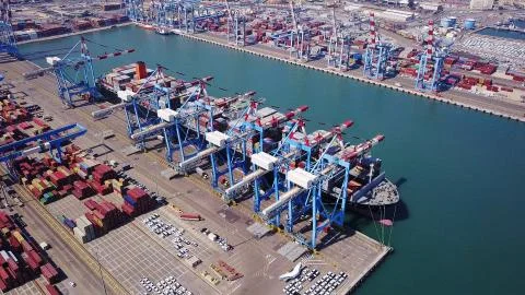 Fully loaded container ships docked at freight port terminal Stock Photos