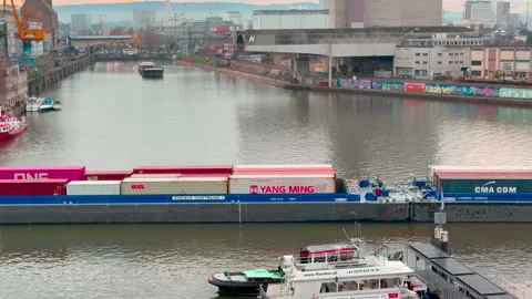 A fully loaded long container riverboat in a narrow harbor basin Видео 331296903