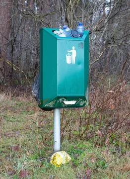 Fully loaded trash bin in the forest Stock Photos