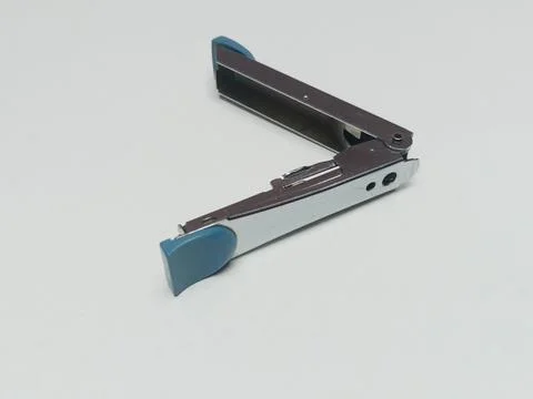 Fully Open Silver Metallic Stapler on White Surface Stock Photos