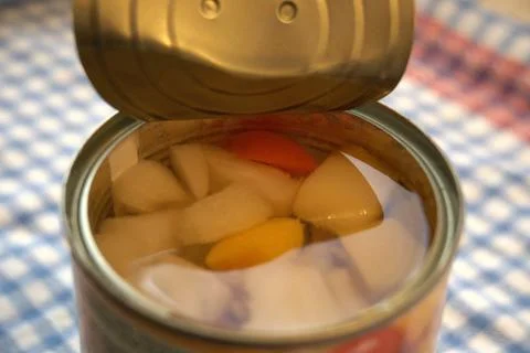 Fully opened fruit salad can with copy space Photos