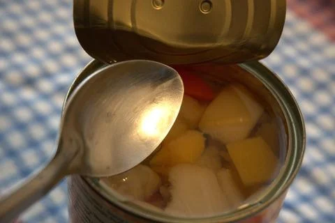 Fully opened fruit salad can with copy space Foto stock