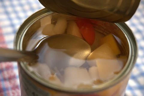 Fully opened fruit salad can with copy space Fotos Stock