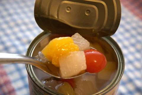 Fully opened fruit salad can with copy space Fotos Stock