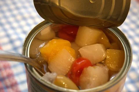 Fully opened fruit salad can with copy space Photos
