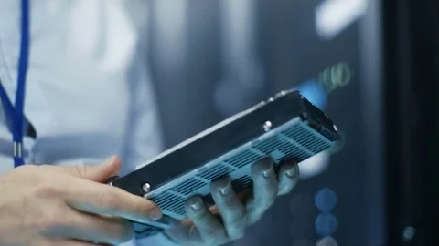 In Fully Working Data Center IT Engineer Installs Hard Drive into Server Rack.  Stock Footage 74630968