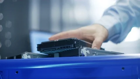 In Fully Working Data Center IT Engineer Installs Hard Drive into Server Rack.  Stock Footage 74631070