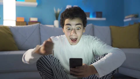The fun and cheerful young man receives the happy news and rejoices. Stock Footage 234096142