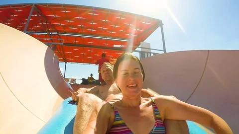 Fun and fast roll off water slide  in water park on sunny day 스톡 동영상 75196812