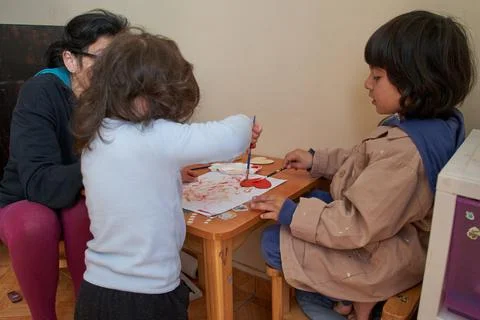 Fun art session. Children make crafts together with mother 스톡 사진