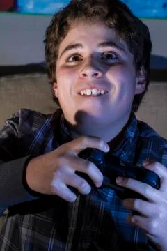 Fun boy with joystick playing computer game at home. Stock Photos
