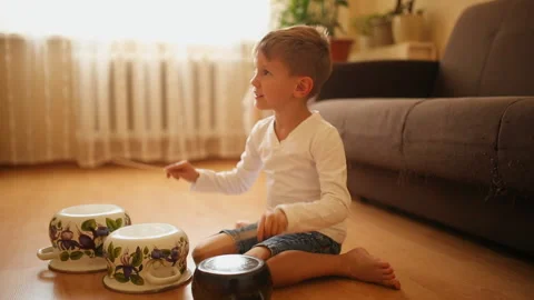 Fun boy play the music using kitchen tools and utensils. Stock Footage 121059825