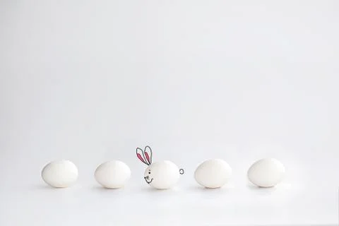 Fun card for Easter. Painted Bunny from an egg on a white background Stock Photos