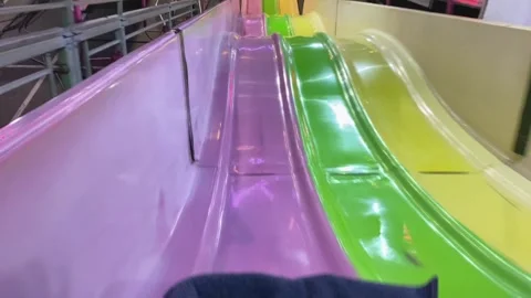 Fun Carnival Ride Slide Tower POV At Night, Feet In Potato Sack Blanket Stock Footage 237676208