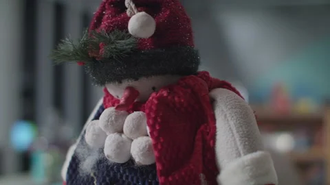 A Fun christmas stuffed snow man toy gets placed for the christmas holiday Stock Footage 138105967