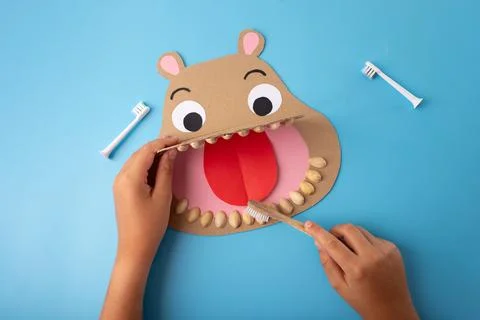 Fun craft project paper-made hippo head with wide-open mouth, cut-out eyes,.. Stock Photos