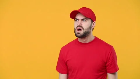 Fun crazy delivery man in red cap blank t-shirt workwear scream in megaphone Stock Footage 136282420