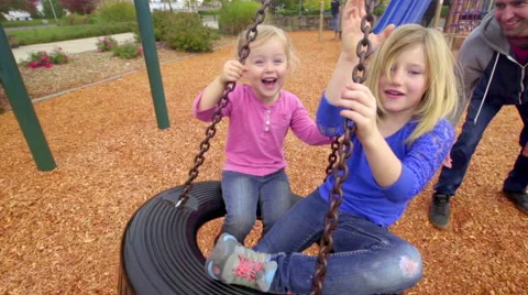 Fun with dad on tire swing Stock Footage 56797151