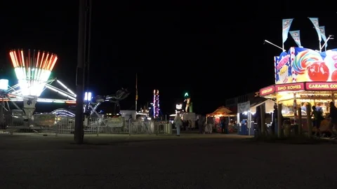 Fun Fair Rides Light Up At Night with Fair Goers Silhouette 動画素材 94217180