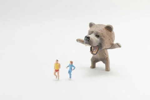 A fun of figure world with bear attack Stock Photos
