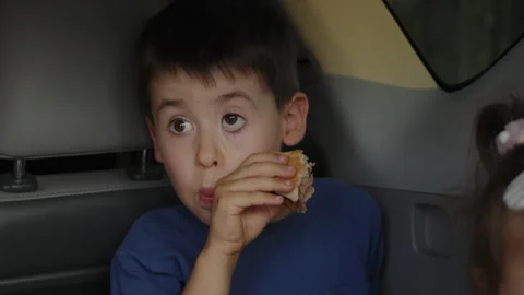 Fun friendly children sitting at trunk of car eating pies Cheerful family making Video stock 249737139