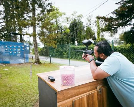 Fun game Paintball Player At The Shooting Range with Paintball marker Stock Photos