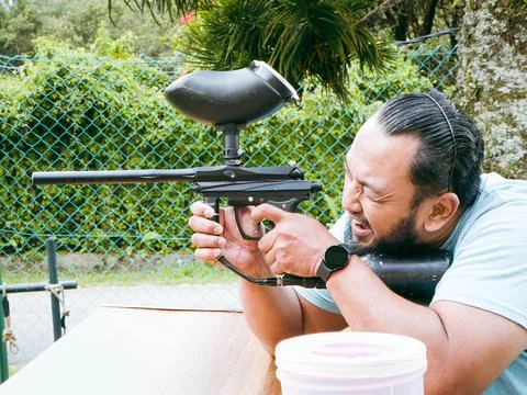 Fun game Paintball Player At The Shooting Range with Paintball marker Stock Photos