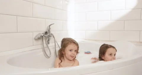 Fun games in the bathroom of the twins Stock Video Pond5
