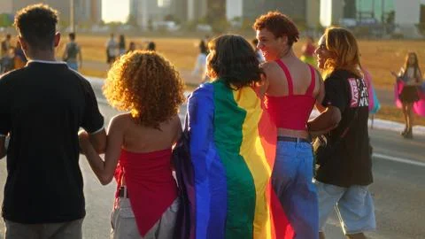 Fun gay non binary friends walk lgbt pride party. Lgbtq parade, queer community. Stock Photos