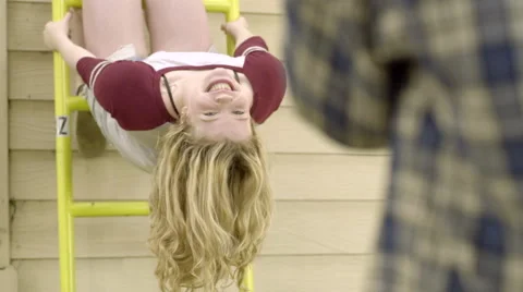 Fun Girl Hangs Upside Down On Ladder And Poses For Photo (Slow Motion) Stock Footage 49967928