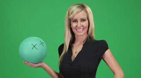 A fun green screen shot of a blonde female model holding a green ball Stock-Footage 38892235