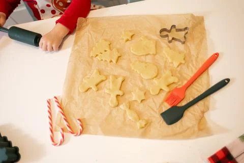 Fun holiday baking session with cookie dough and festive shapes on the kitc.. Stock Photos