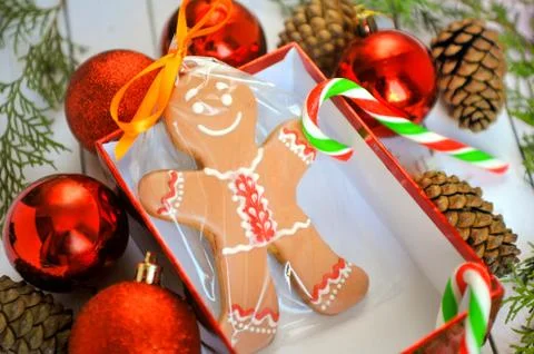 Fun image of smiling gingerbread man with peppermint stick in holiday snowflake Stock Photos