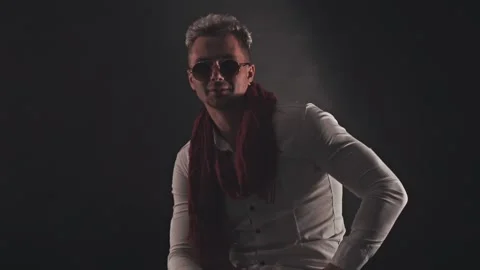 Fun man in a red scarf on a dark background Stock Footage 121817786