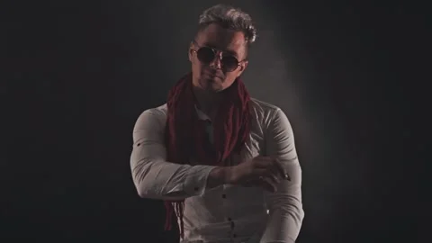 Fun man in a red scarf on a dark background Stock Footage 121817983