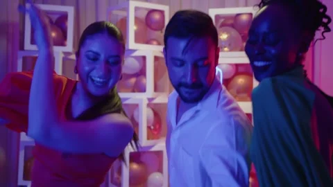 Fun multiethnic friends dancing at elegant birthday party evening celebration Stock Footage 294565732