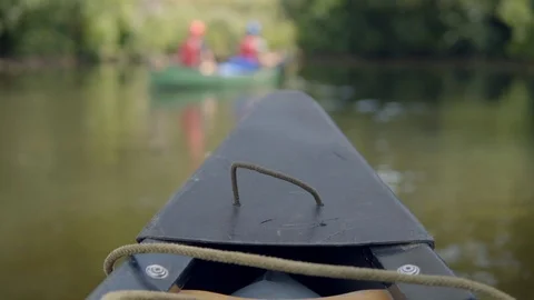Fun paddling down a peaceful river in a canoe Stock Footage 97703926