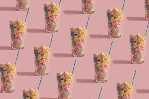 Fun pattern made of big glasses full of colorful candy with straw. Creative p Stock Photos