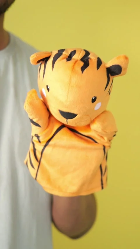 Fun puppet show with a tiger hand puppet in bright colors Stock Footage 336474773