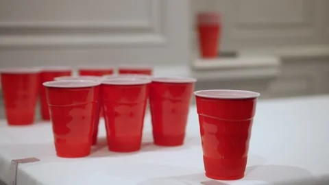 The Fun Red Cup Game is an exciting activity for friends to unwind and have fun Video stock 314576228