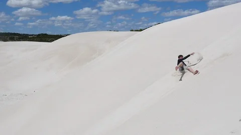 Fun roll down the dune challenge Stock Footage 106938534