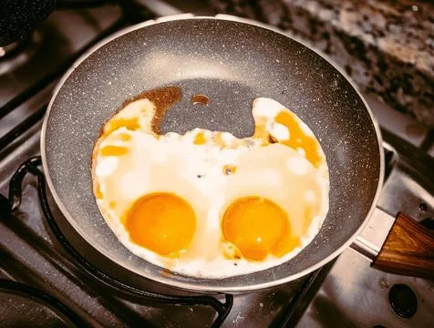 Fun-shaped fried eggs Stock Photos