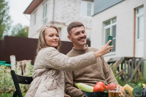 Fun time in self-isolation. A guy and a girl had a delicious picnic with grilled Stock Photos